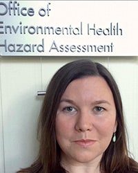 Elizabeth Marder standing under a sign that says Office of Environmental Health Hazard Assessment