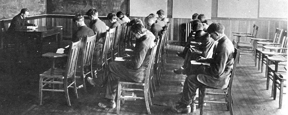 Black and white photo of an early English class. 